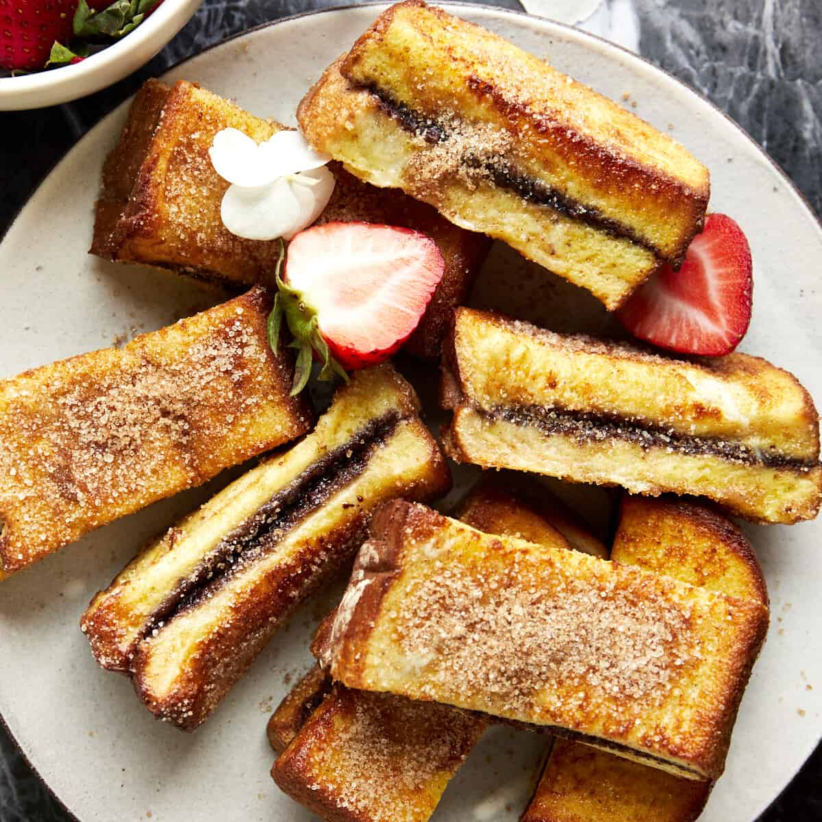 Air fryer Nutella French toast sticks on a plate.