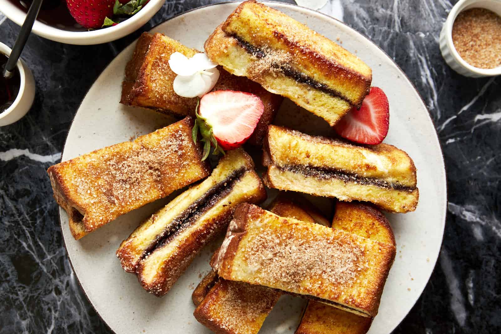 Air fryer Nutella French toast sticks on a plate.