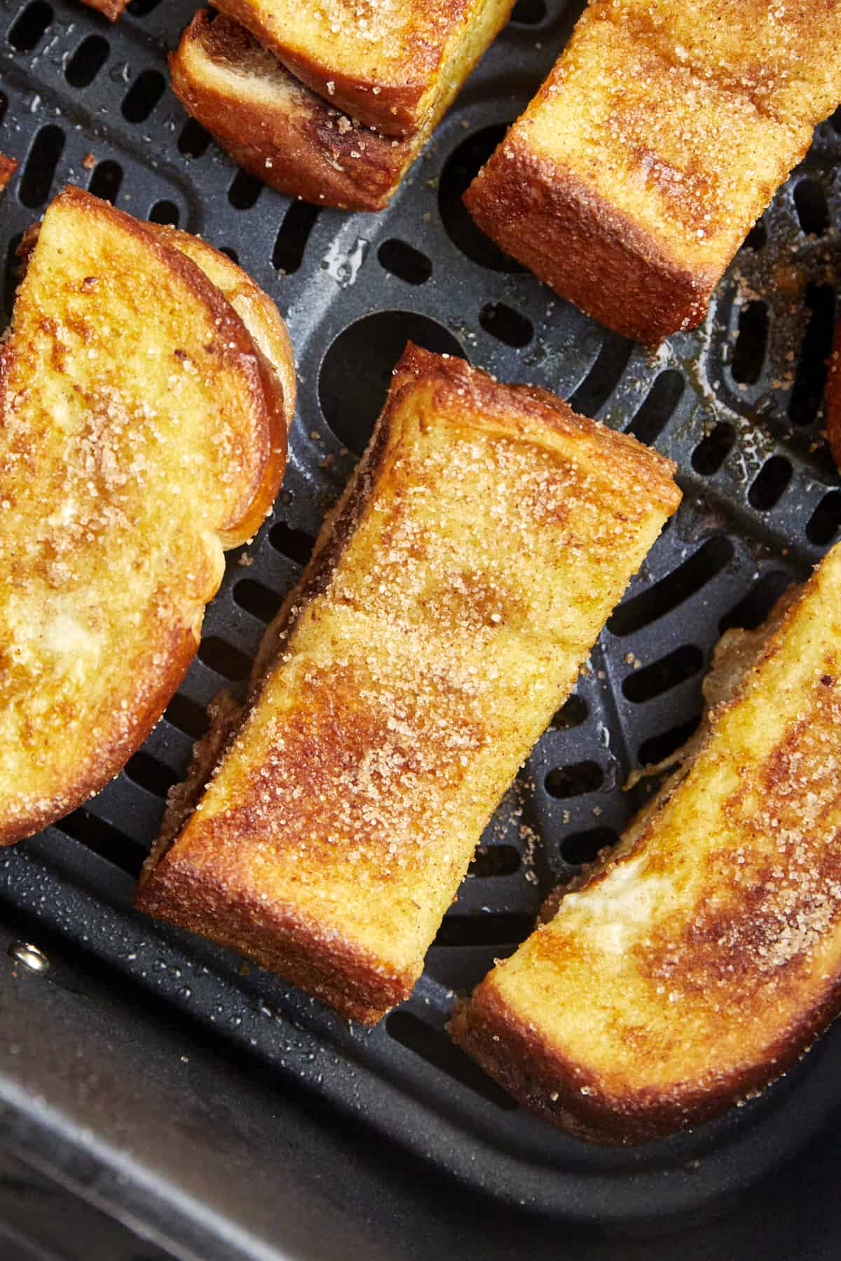 Nutella French toast sticks in an air fryer basket. 