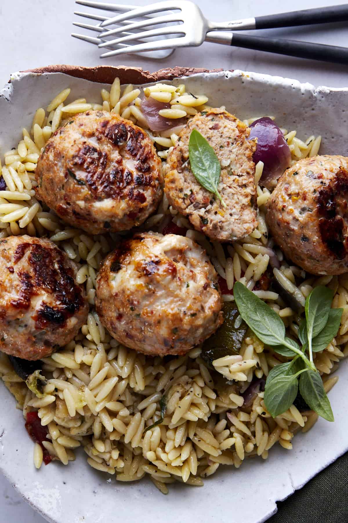 A plate of Mediterranean chicken meatballs over rice. 