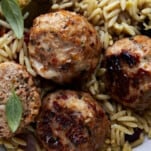 Close up image of sun-dried tomato chicken meatballs over rice.