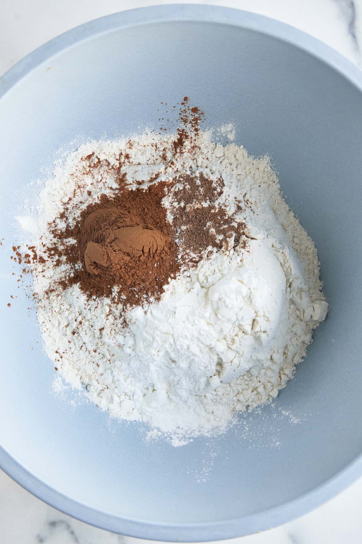 Flour, cornstarch, baking powder, and cinnamon in a bowl. 