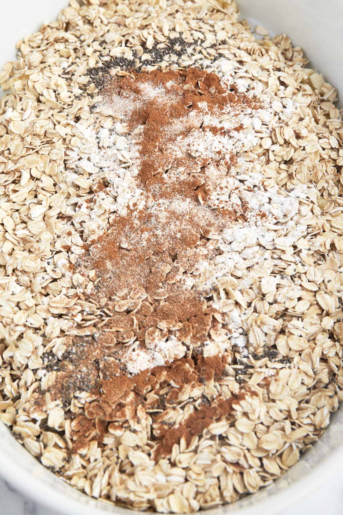 Dry ingredients for baked apple oatmeal in a baking dish. 