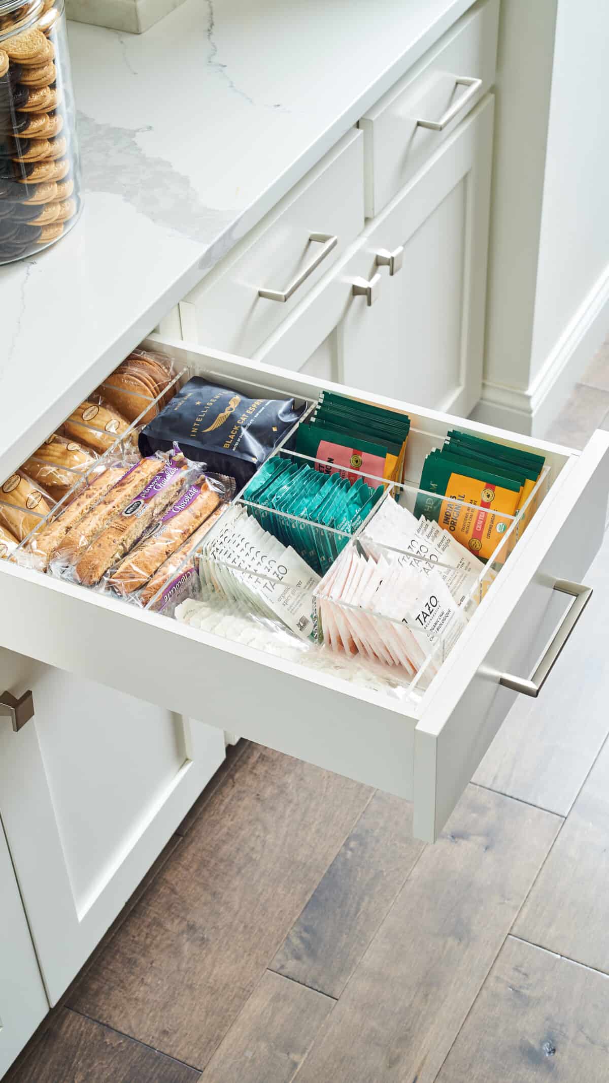 Open drawer with coffee, tea, and snacks.