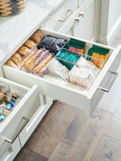 A drawer with organized tea and snacks.