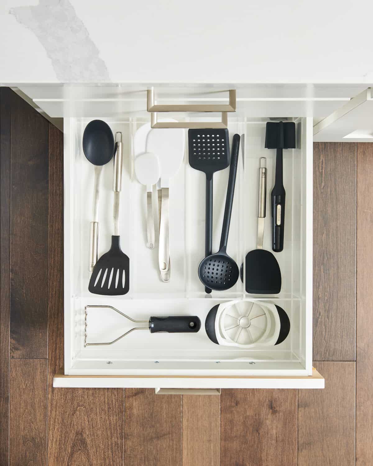 various kitchen tools organized in a drawer.