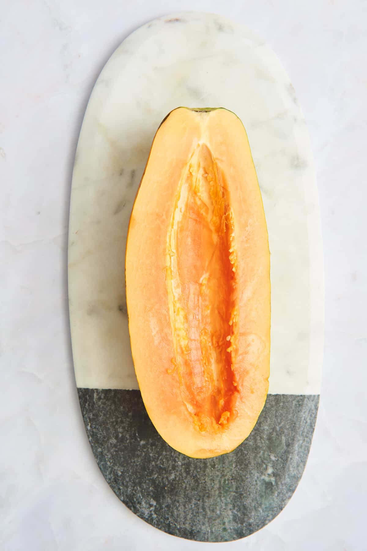 Half a papaya with the seeds removed. 