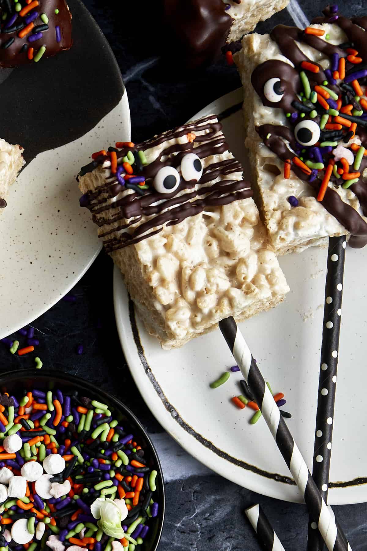 Halloween rice krispie treats with paper straws sticking out. 