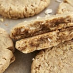 Oatmeal peanut butter cookies with one split in half.