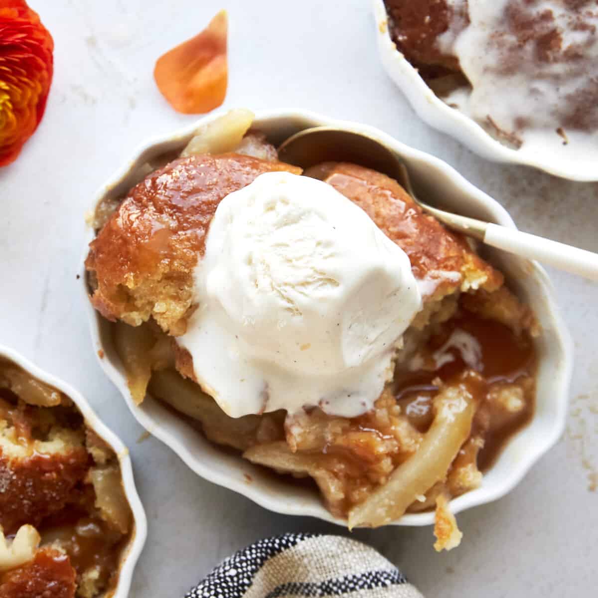 Overhead image of a ramekin full of pear cobbler topped with ice cream.