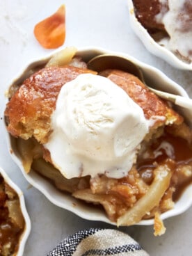 Overhead image of a ramekin full of pear cobbler topped with ice cream.