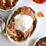Overhead image of pear cobbler topped with vanilla ice cream.