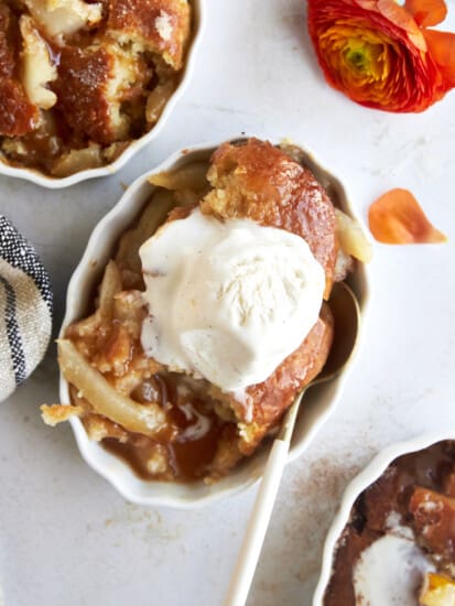 Overhead image of pear cobbler topped with vanilla ice cream.