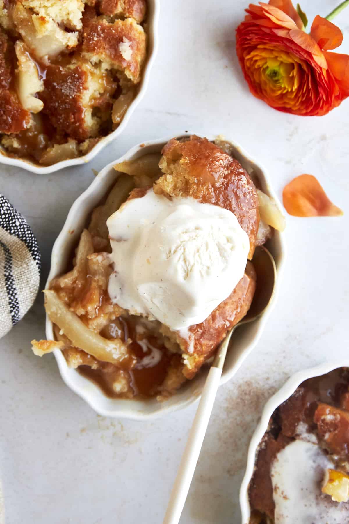 Servings of pear cobbler topped with ice cream. 