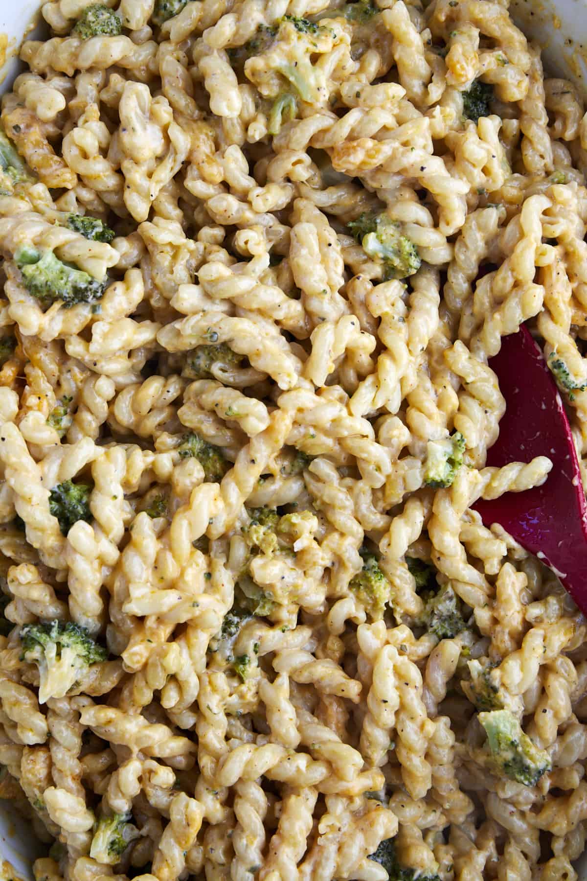 Close up image of a baking dish full of baked broccoli mac and cheese.