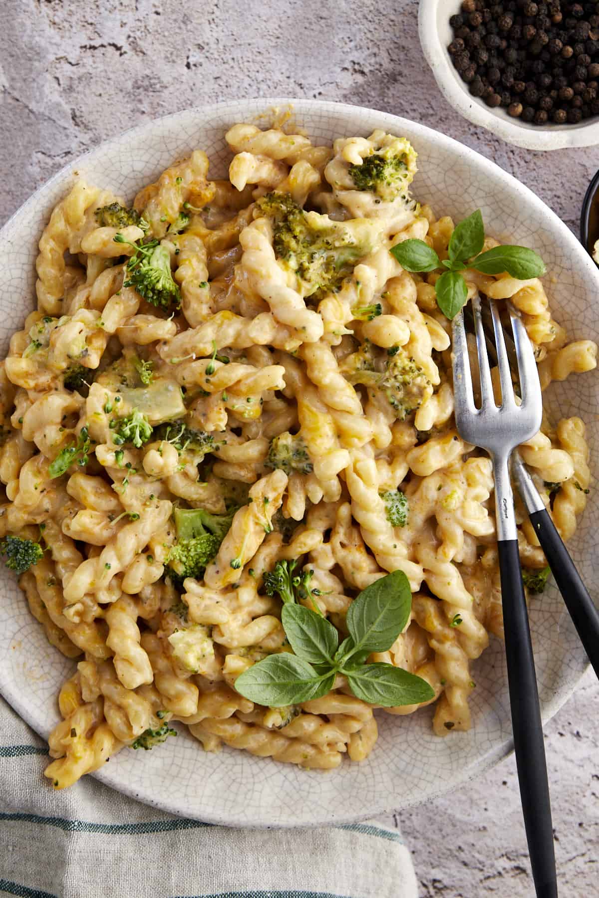 A bowl of baked mac and cheese with two forks. 