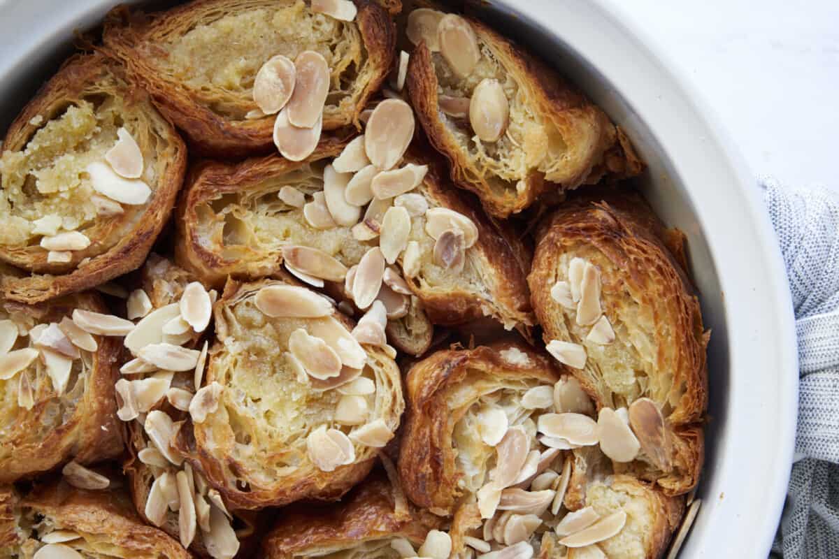 A baking dish full of almond croissant French toast. 