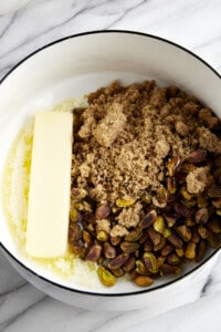 Butter, brown sugar, pistachios, and salt in a saucepan.