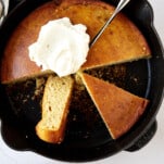 A skillet of brown butter cornbread topped with whipped butter.