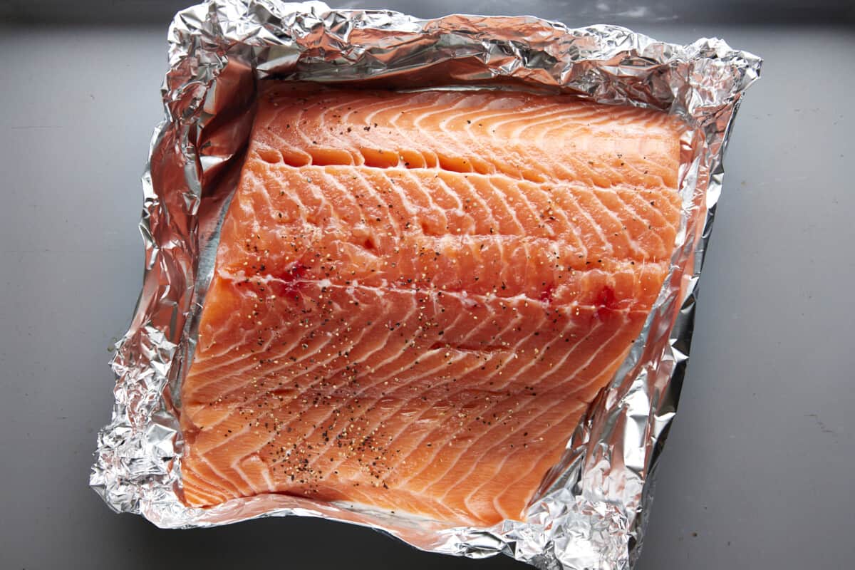 A large salmon filet in a foil packet. 