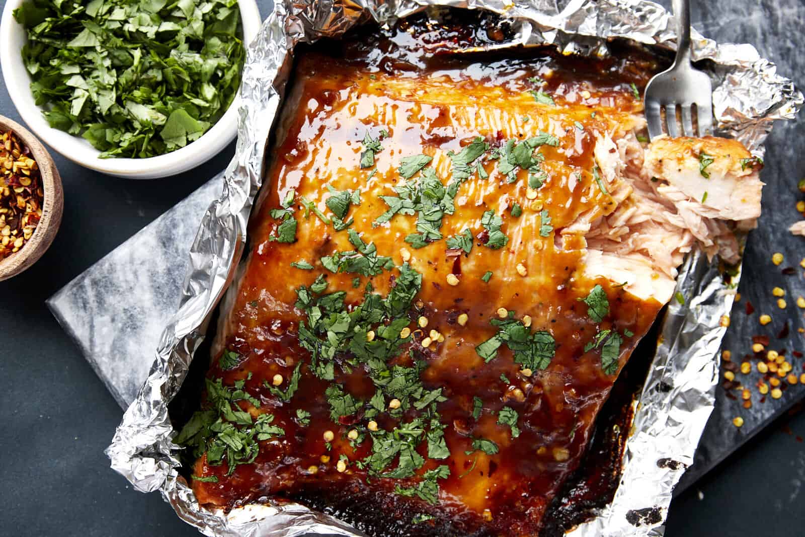 Honey garlic salmon in a foil packet topped with cilantro.