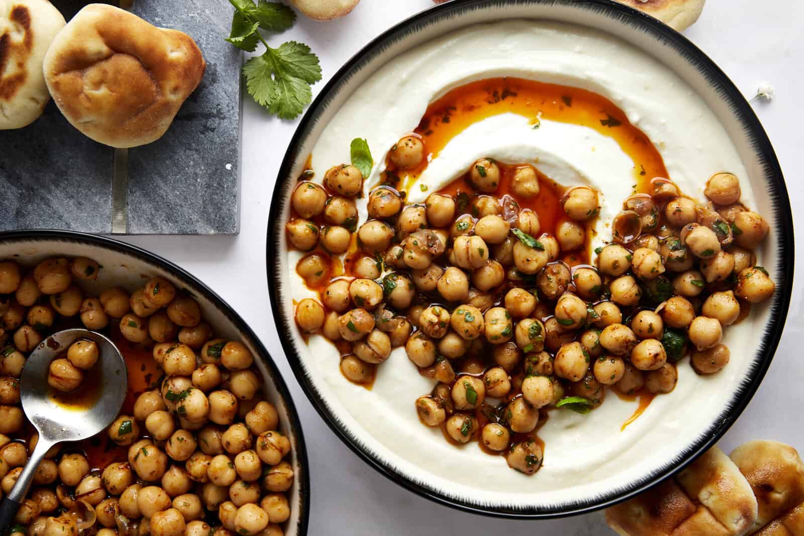 A bowl of whipped feta topped with marinated chickpeas.