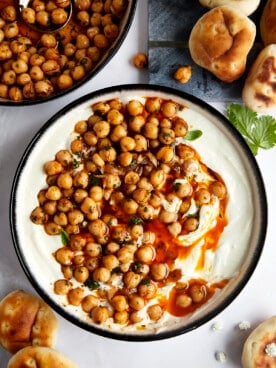 A bowl of whipped feta topped with marinated chickpeas.