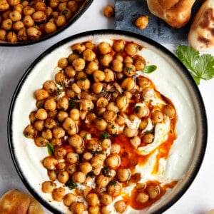 A bowl of whipped feta topped with marinated chickpeas.