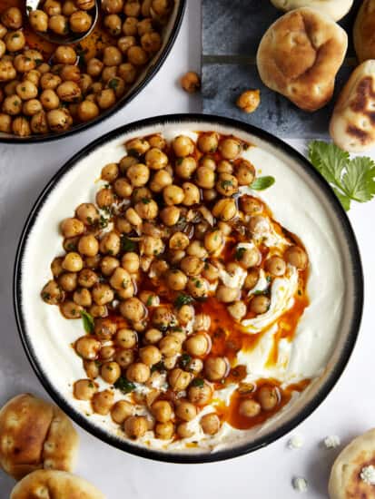 A bowl of whipped feta topped with marinated chickpeas.