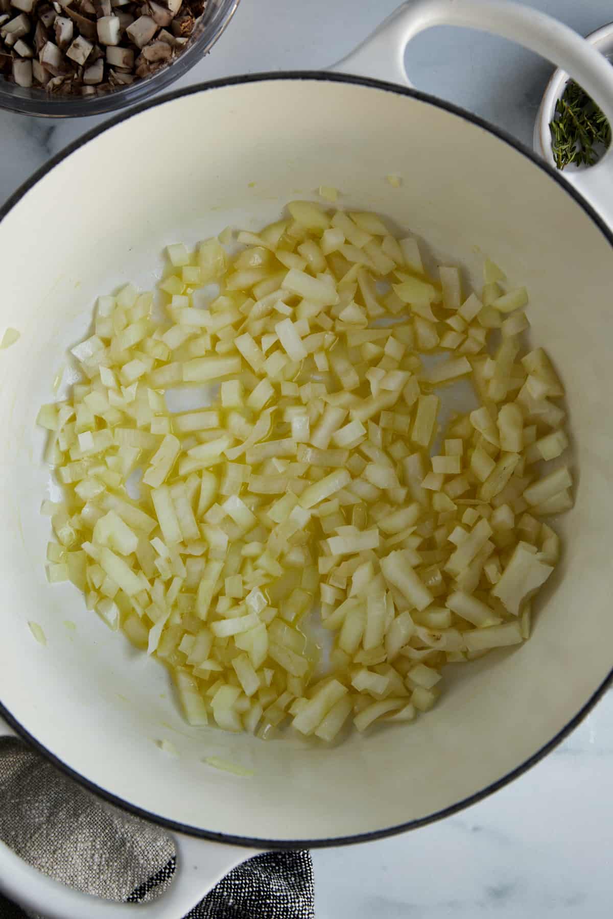 Onions sautéing in butter and oil in a large pot.