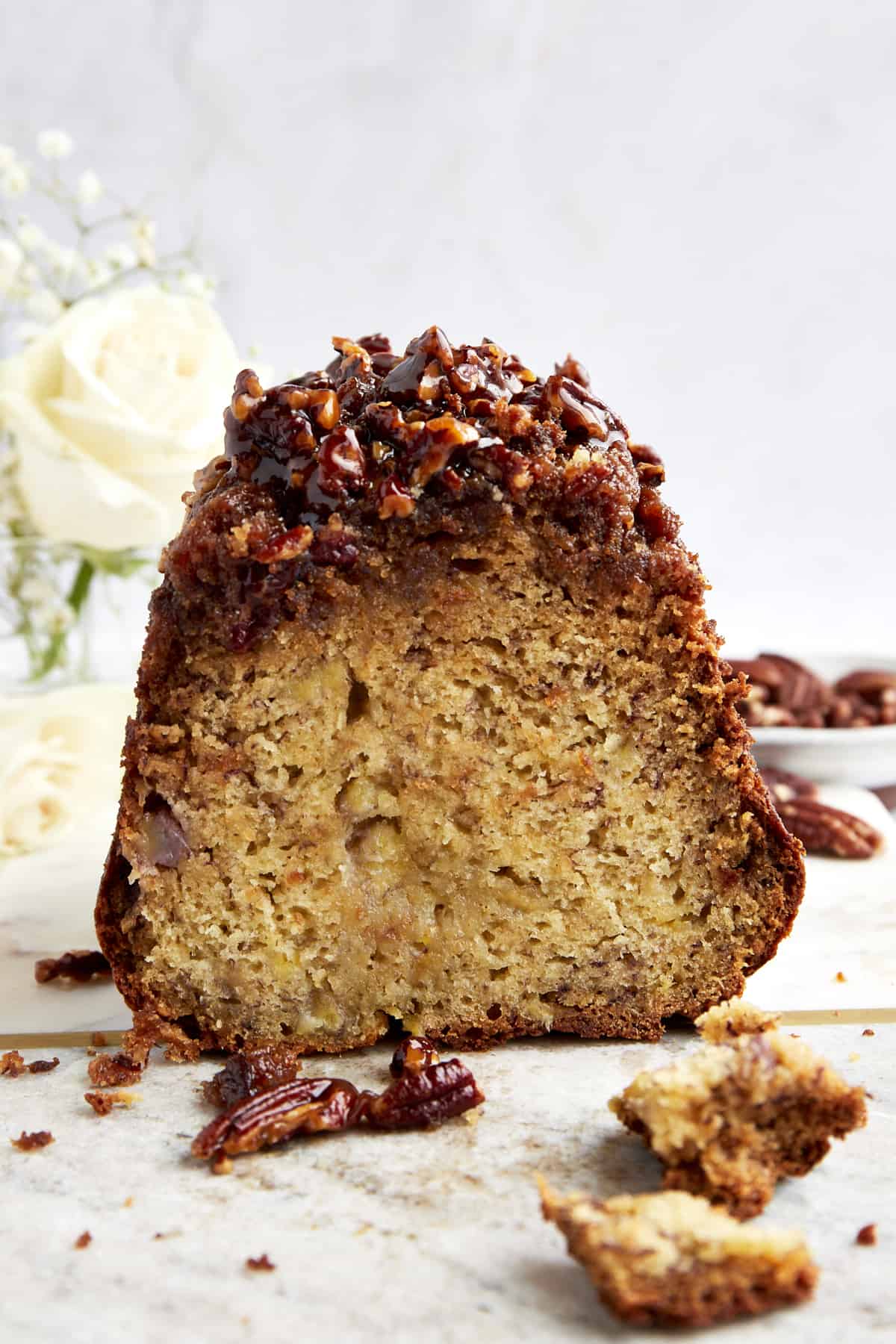 Side view of easy banana pecan bread with a sticky pecan topping. 