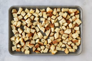 Bread pieces on a baking dish.