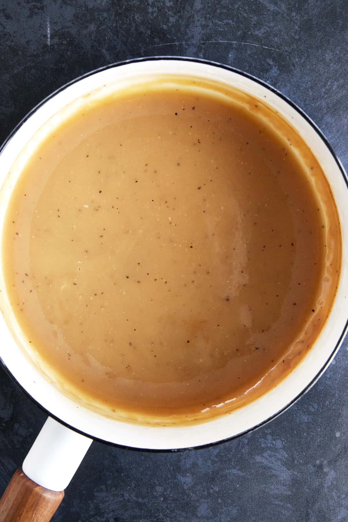 Homemade turkey gravy in a saucepan. 