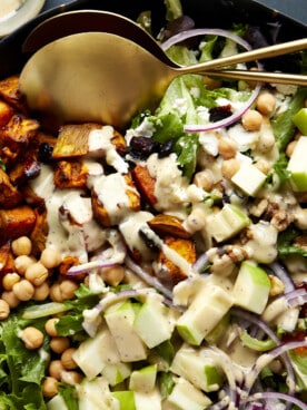 A sweet potato salad topped with tahini dressing.