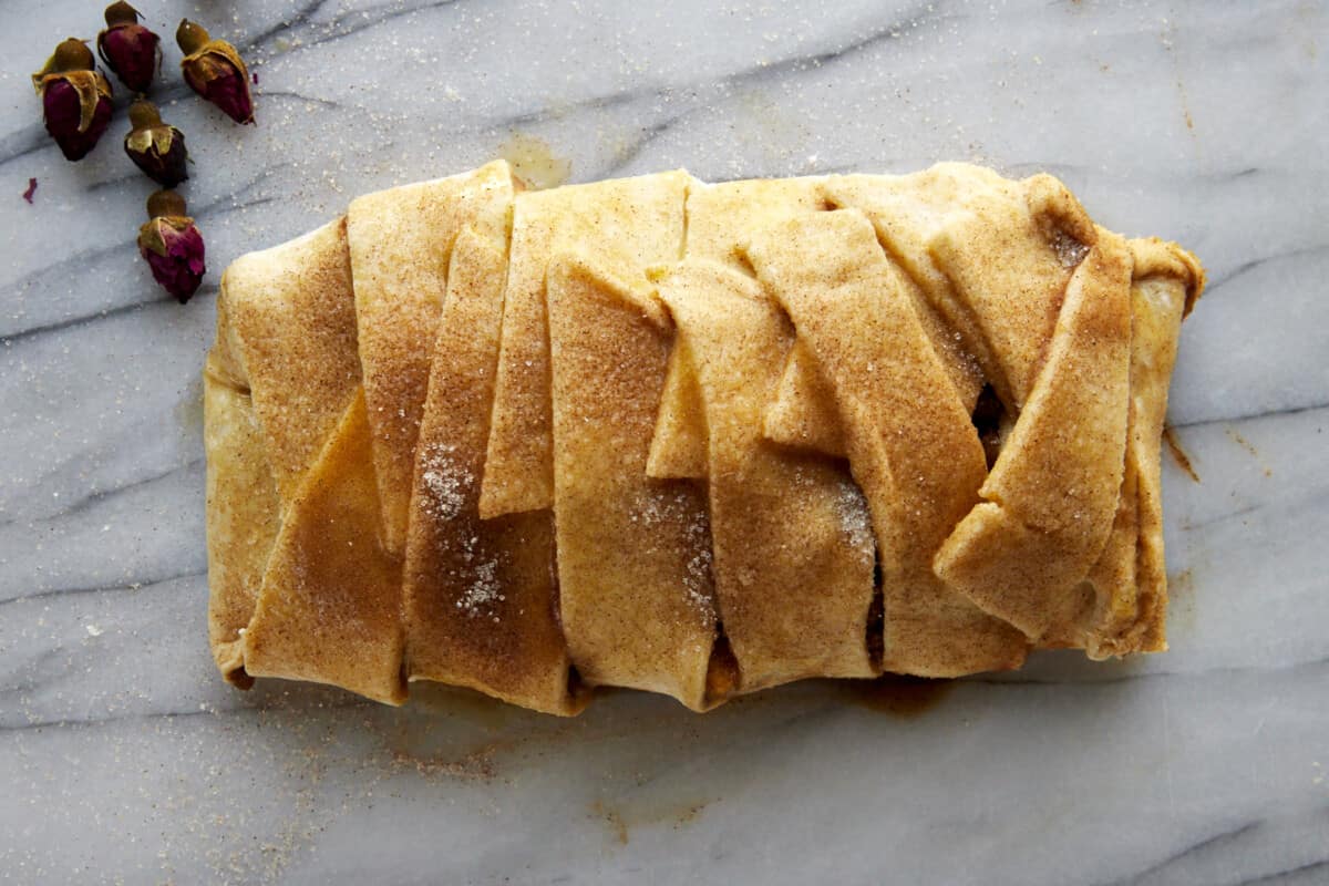 An unbaked apple puff pastry braid. 