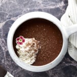 A mug of bone broth hot chocolate topped with whipped cream.