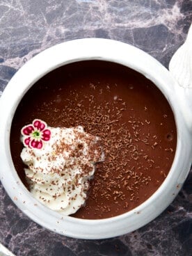 A mug of bone broth hot chocolate topped with whipped cream.