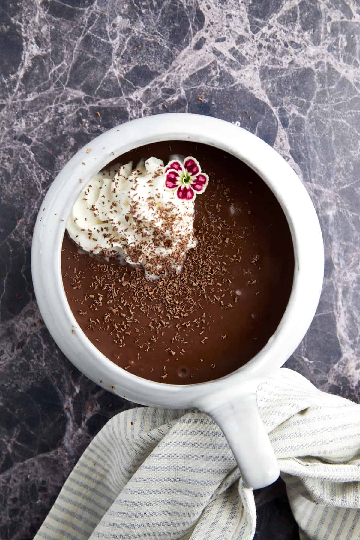 Bone broth hot chocolate topped with whipped cream and chocolate shavings.