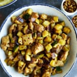 A bowl of chicken and zucchini stir fry.