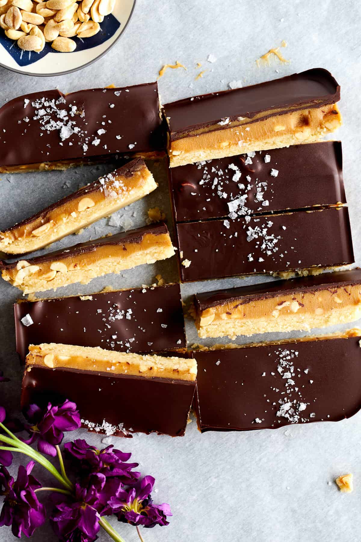 Homemade healthy snickers bars topped with flakey salt. 
