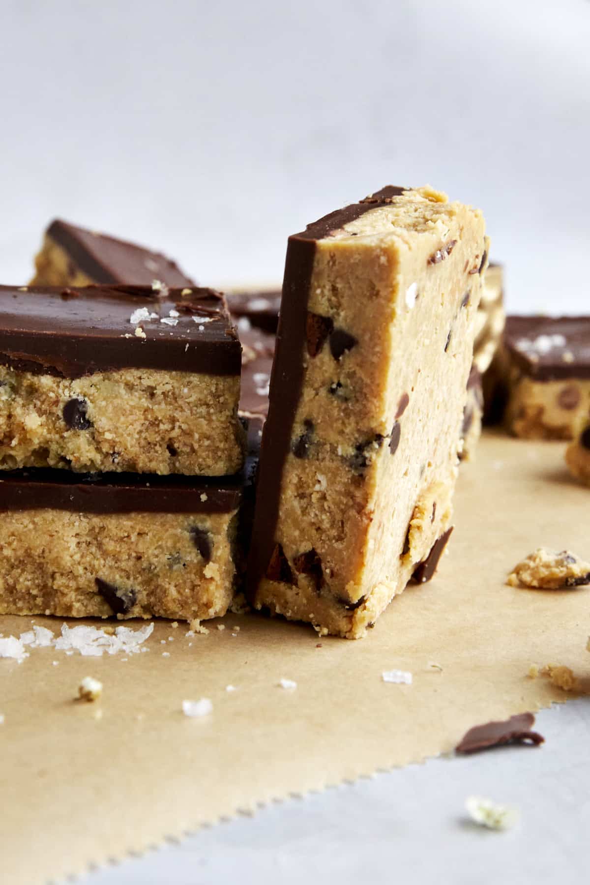 A cookie dough bar on its side next to two stacked on top of each other. 