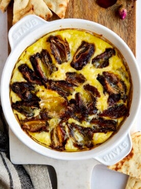 Eggs and dates in a round baking dish.