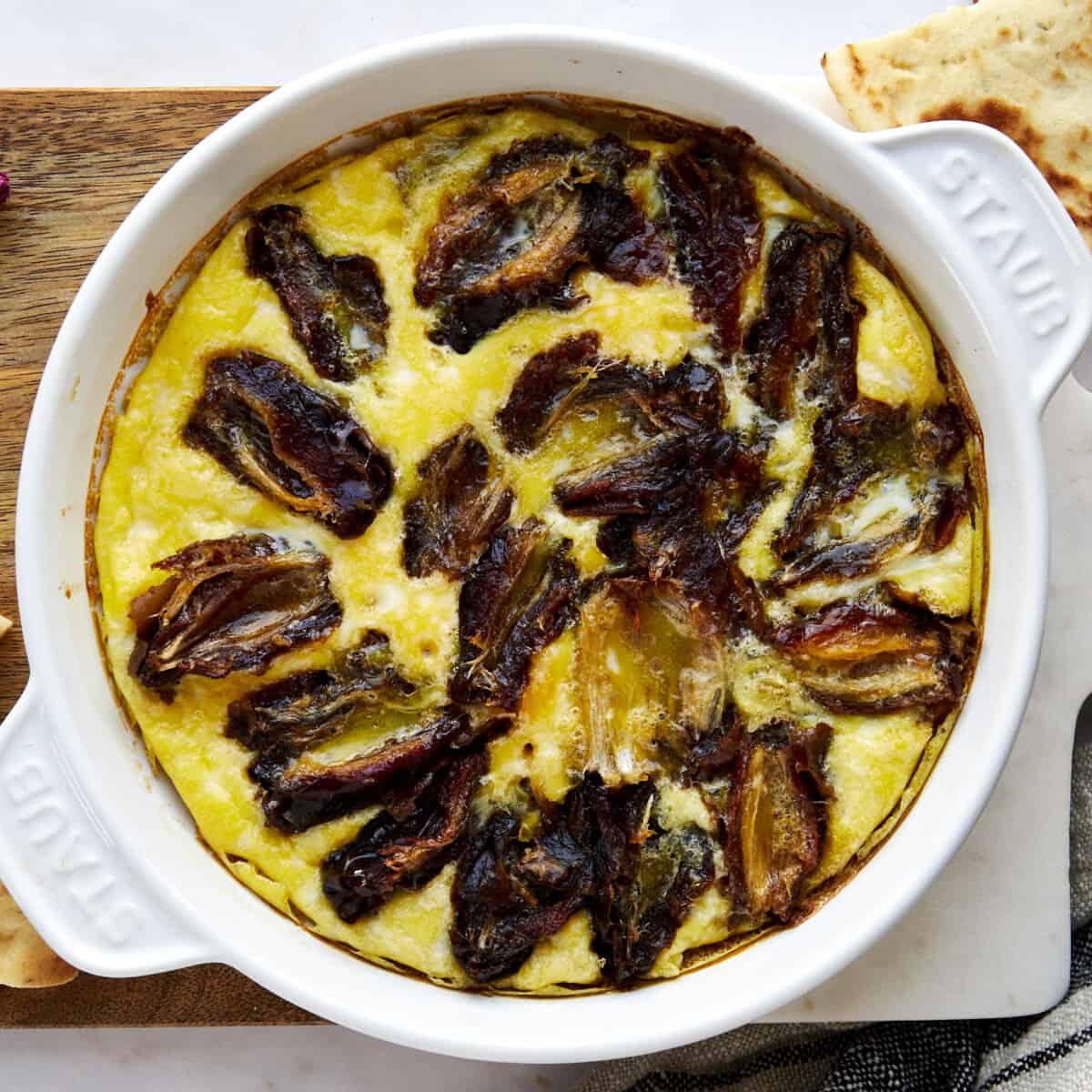 eggs and dates in a round baking dish.
