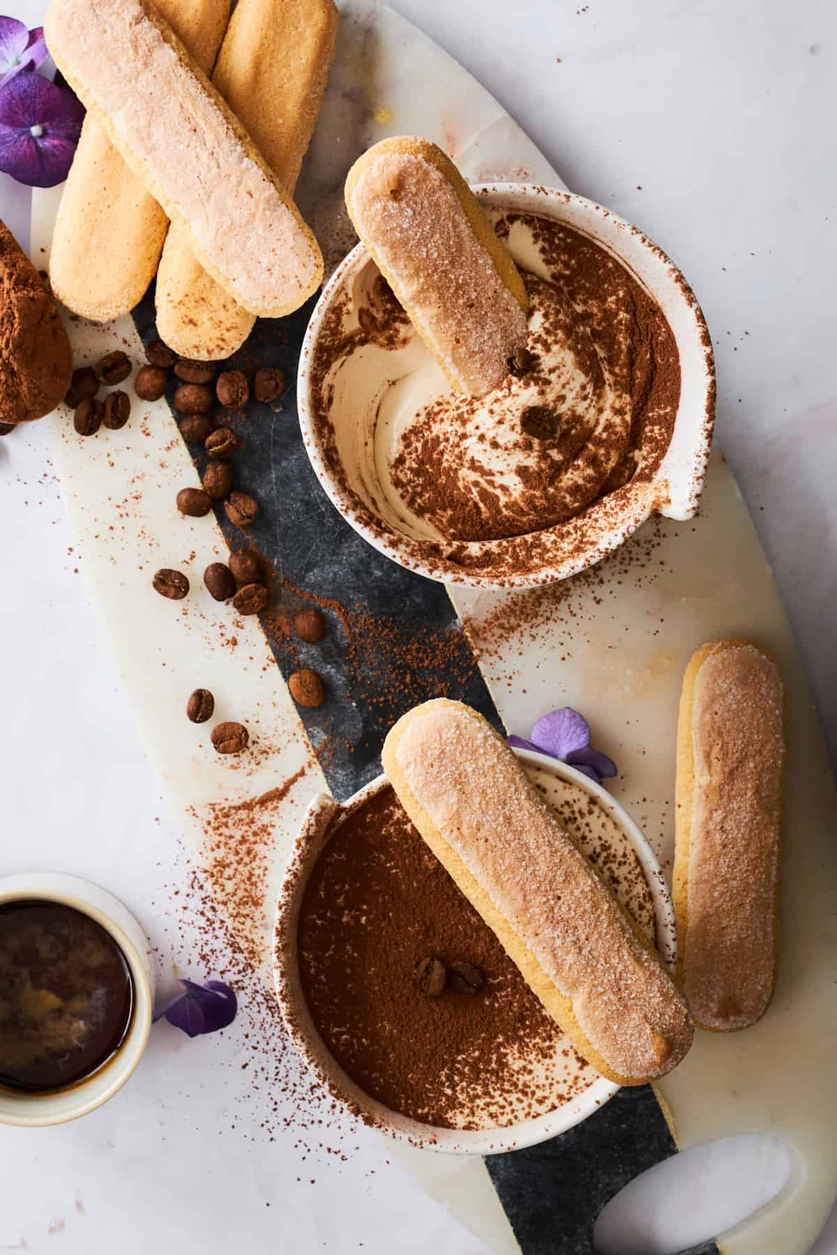 Bowls of tiramisu dip with ladyfinger cookies.