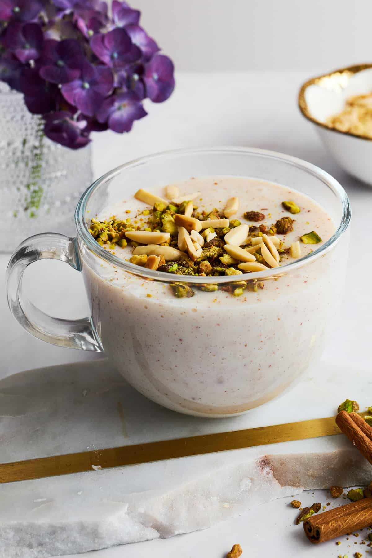 A mug of Sahlab topped with crushed nuts. 