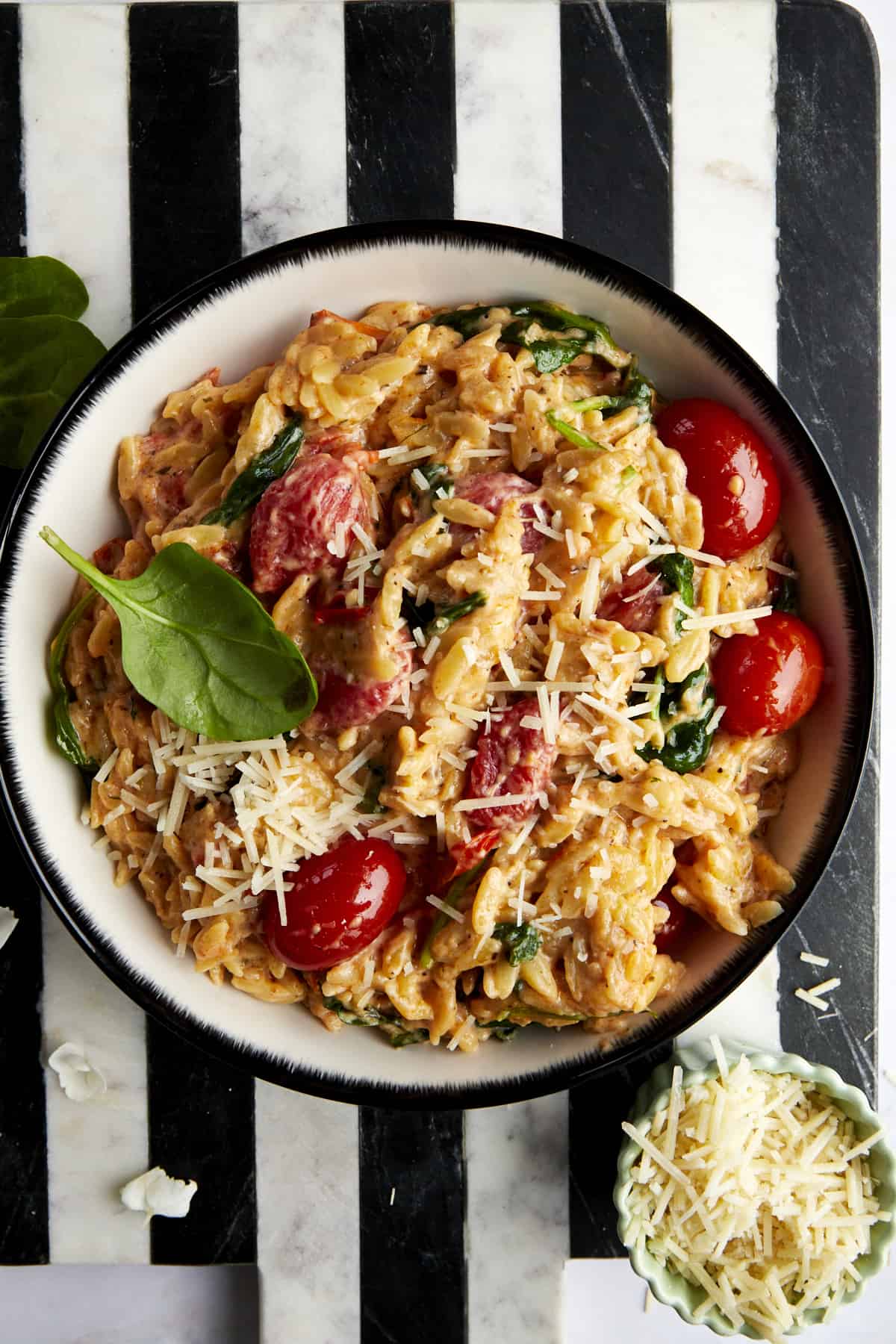 A bowl of Boursin cheese pasta topped with parmesan cheese.