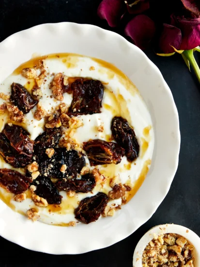 A bowl of honey whipped ricotta and roasted dates.