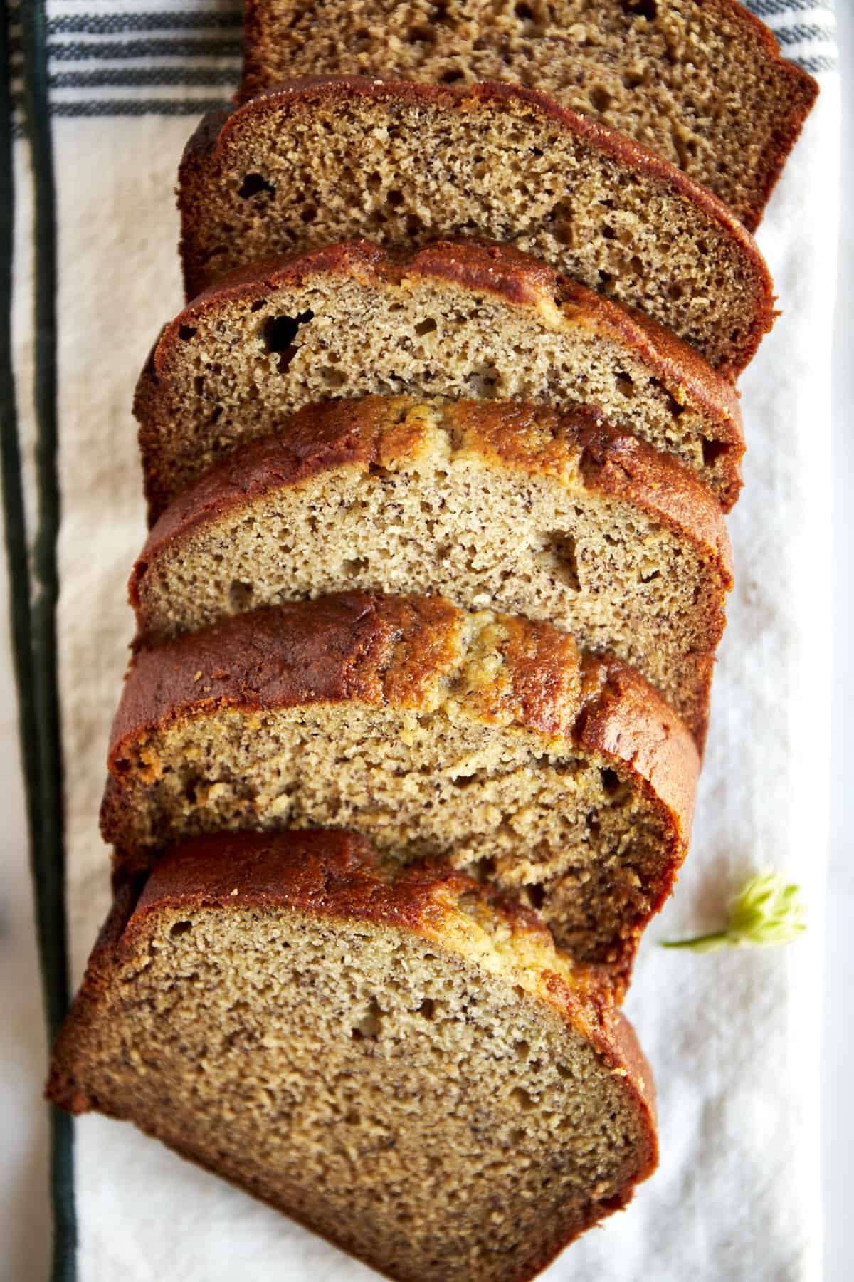 A loaf of blender banana bread sliced into pieces. 