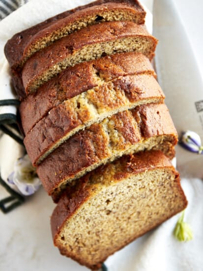 A loaf of blender banana bread sliced into pieces.