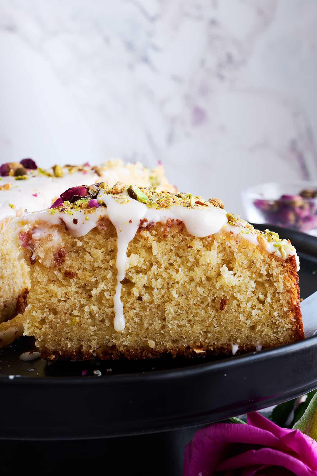 Side view of an iced Persian love cake slice.